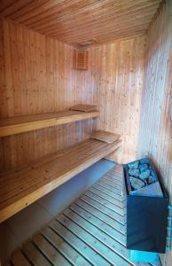 a wooden sauna with a bench and a box at Solar da Bica in São Vicente