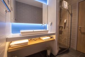 a bathroom with a sink and a mirror at Holiday Inn Express - Ljubljana, an IHG Hotel in Ljubljana