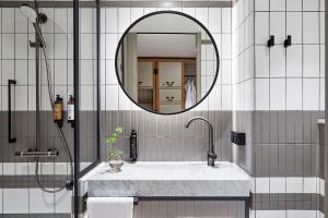 a bathroom with a sink and a mirror at PURO Warszawa Centrum in Warsaw +34 photos