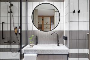 a bathroom with a mirror and a sink at PURO Warszawa Centrum in Warsaw