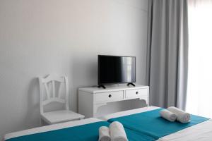 a hotel room with a bed and a television at BLUESEA Mediodia in El Arenal