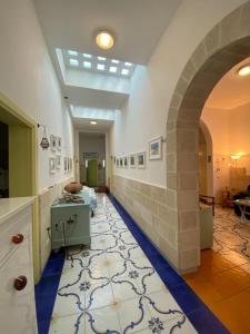 a large room with a tile floor and an archway at Villa Lucky in Punta Prosciutto