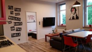 a living room with a couch and a table at Street Art Apartment in Oświęcim