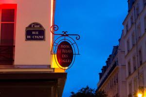 a sign for a hotel on the side of a building at Hôtel Le Relais des Halles in Paris