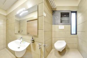 a bathroom with a toilet and a sink at Nestlay Rooms Vanagaram in Chennai +21 photos