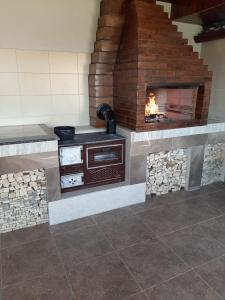 a stone fireplace with a stove in a room at Casa Horea in Oradea