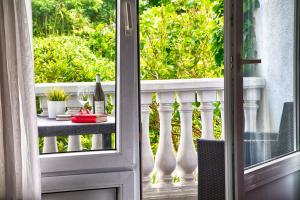 een open deur naar een balkon met een tafel en een fles wijn bij Ferienanlage Duhnen Haus 19 in Cuxhaven