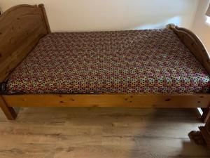 ein Bett mit einem Holzrahmen in einem Zimmer in der Unterkunft Delta 4 Nice apartment 2 big bed in Tartu