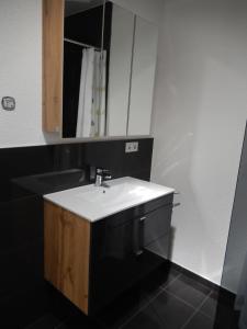 a bathroom with a white sink and a mirror at Haus Stadler in Irsch