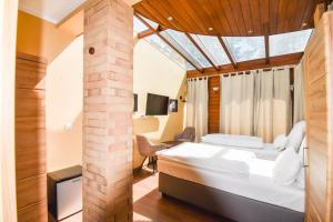 a bedroom with a bed and a brick pillar at Boutique Hotel Sena in Berlin