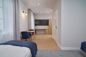 Posteľ alebo postele v izbe v ubytovaní Apartamenty Queen
