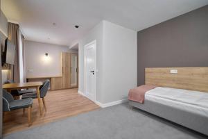 Posteľ alebo postele v izbe v ubytovaní Apartamenty Queen