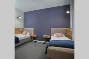 Posteľ alebo postele v izbe v ubytovaní Apartamenty Queen