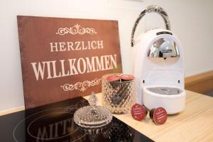 a kitchen counter with a hellowell willushima sign and a toaster at Fürstenhäusl Alpbach in Alpbach