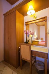 a bathroom with a vanity and a large mirror at Acropole Delphi City Hotel in Delphi