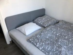 a bed with two pillows on top of it at Appartements in Basel - Leymen in Leymen