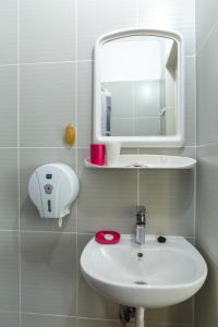 a bathroom with a white sink and a mirror at Vila Primavera in Vama Veche