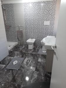 a black and white bathroom with a sink and a toilet at Villa Angel in Bovalino Marina