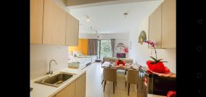 a kitchen with a sink and a kitchen with a couch at LCP T1 Honeymoon genting highland midhill homestay in Bentong