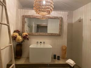a bathroom with a white sink and a mirror at LUZZ me - Casas de Santa Bárbara in Santa Bárbara +68 photos