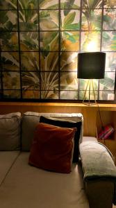 a couch with a lamp and a painting on the wall at Janika's Patio in Porto