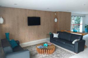 a living room with a couch and a table at Rua Dr Diogo de Faria, 671 apto 81 in Sao Paulo