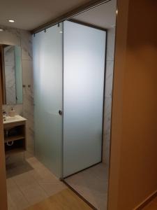
a bathroom with a shower and a sink at Sonia Hotel & Suites in Kos Town
