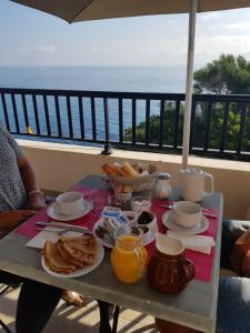 a table with breakfast food on top of a balcony at Maison Bella Vista in Cagnano