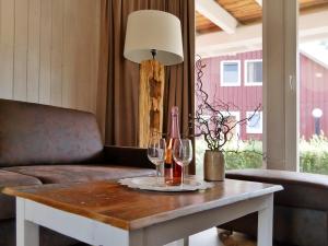 a table with two wine glasses and a lamp at Ferienpark Scharmützelsee in Wendisch Rietz