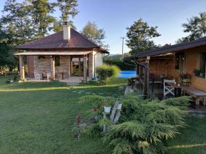 a house with a picnic table and a yard at Vikendica Ranč Terzić in Čačak