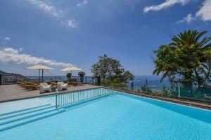 a swimming pool with a view of the ocean at Quinta Mirabela - Design Hotel in Funchal