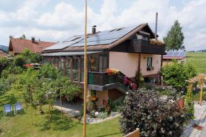 a house with solar panels on the roof at Ferienwohnungen Claus in Frauenau
