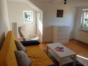 a living room with a couch and a table at Ferienwohnung Willi B. in Eisenach