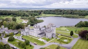 an aerial view of a castle and a lake at Dromoland Castle in Newmarket on Fergus