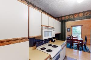 a kitchen with a stove and a microwave at Heaven's View in Sevierville