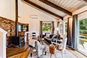 a living room with a couch and a fireplace at Tall Cedars Cabin By The Water in Eastsound