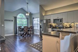 an open kitchen and dining room with a table and chairs at Branson Resort Condo - 2 Miles to Table Rock Lake! in Branson