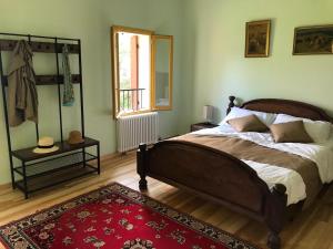 a bedroom with a large bed and a red rug at La Torre di Rua in San Pietro di Feletto
