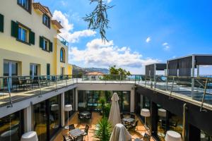 a view of the balcony of a hotel with a swimming pool at Quinta Mirabela - Design Hotel in Funchal