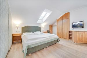 Postel nebo postele na pokoji v ubytování Gasthof Hotel Hauslwirt