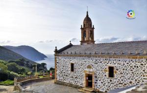 a stone building with a clock tower on top of it at Casa Rural O Rabadan in Cedeira