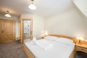 Postel nebo postele na pokoji v ubytování Hotel Zlaty Lev