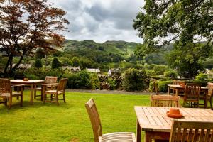 a group of tables and chairs in the grass at The Swan at Grasmere- The Inn Collection Group in Grasmere