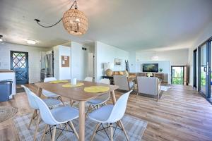 a dining room and living room with a table and chairs at Modern Lake Michigan Home with 3 Lakefront Decks! in Holland