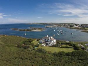 an aerial view of a house and a harbor with boats at The Old Schoolhouse Inn in Comber