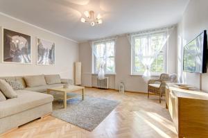 a living room with a couch and a table at Dom & House - Apartments Old Town Szeroka in Gdańsk