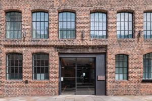 a brick building with a revolving door in front at The Resident Liverpool in Liverpool