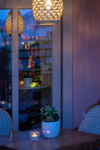a table with a potted plant on it in front of a window at Marpessa Hotel & Spa in Agrinion