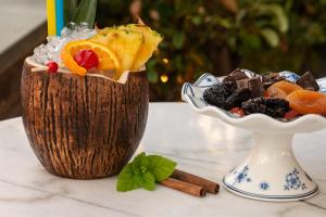 a vase filled with fruit and a bowl of cookies at Marpessa Hotel & Spa in Agrinion