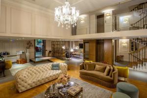 a large living room with a couch and a chandelier at Marpessa Hotel & Spa in Agrinion